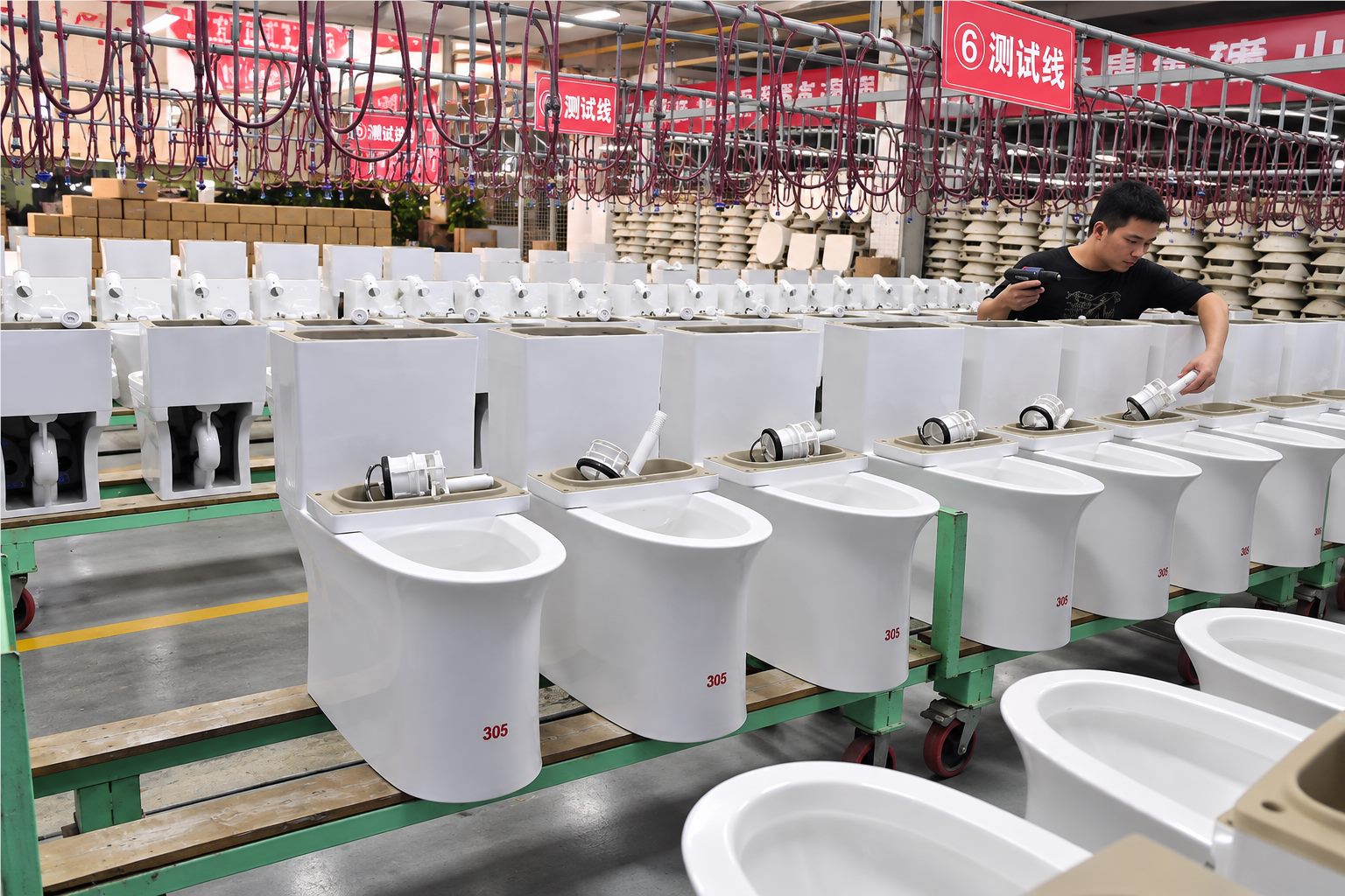 Worker inspecting toilet products